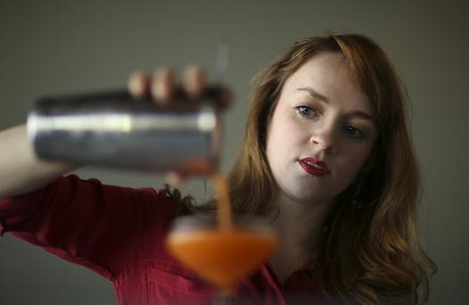 Britt Tracy, bar manager at Heyday in Minneapolis, with the Orange Mustache, a new drink she's been working on.