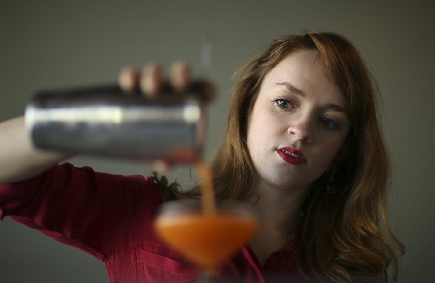 Britt Tracy, bar manager at Heyday in Minneapolis, with the Orange Mustache, a new drink she's been working on.