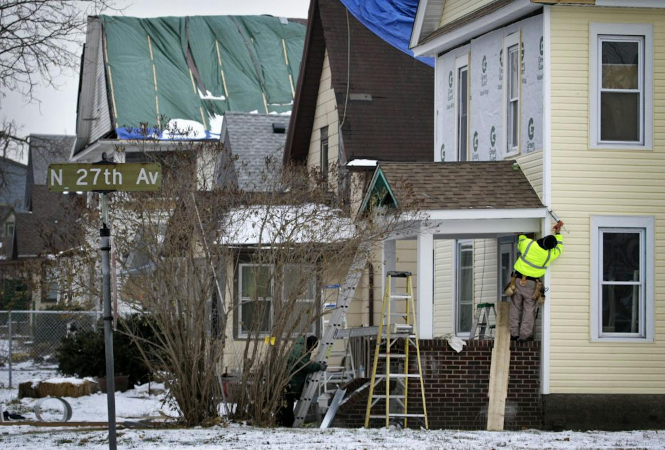 Construction workers repaired the roof on a house damaged by a tornado this summer at the intersection of 27th Avenue N. and Oliver Avenue N.