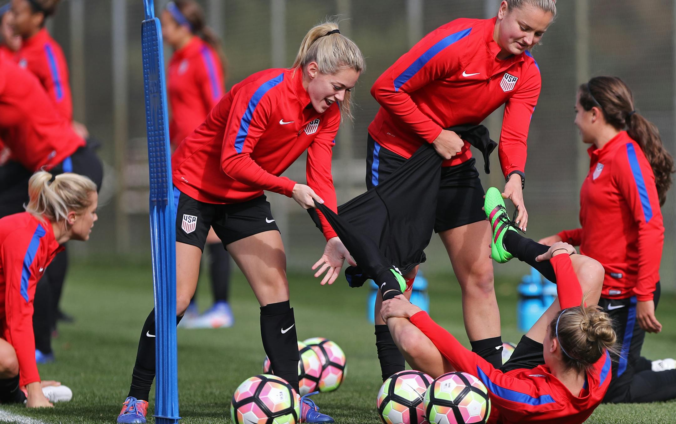 Abby Dahlkemper, left, helped pull off the warmups from a teammate Friday while the U.S. women’s soccer team practiced at Elizabeth Lyle Robbie Stadium in advance of their match Sunday at U.S. Bank Stadium.