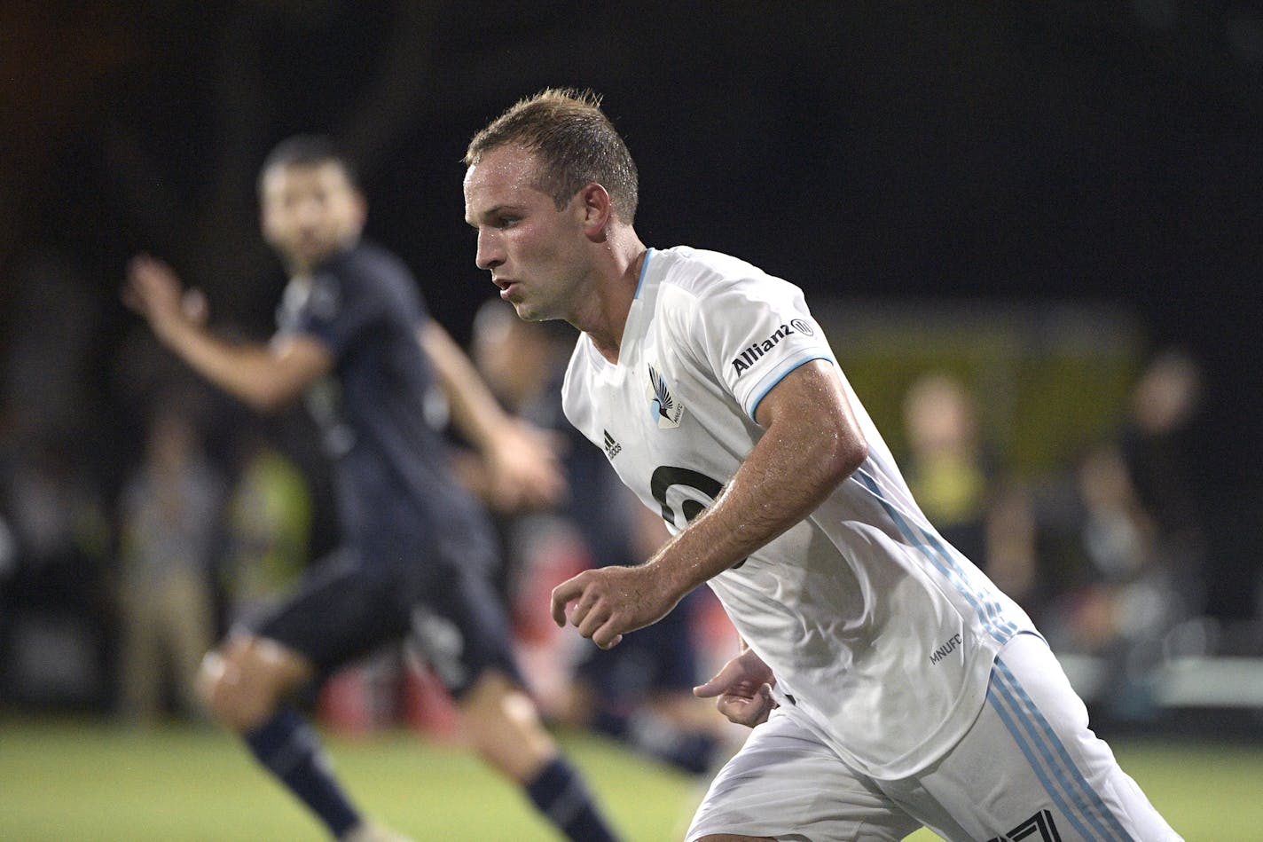 Minnesota United defender Chase Gasper (77) follows a play during the second half of an MLS soccer match against Sporting Kansas City, Sunday, July 12, 2020, in Kissimmee, Fla. (AP Photo/Phelan M. Ebenhack)