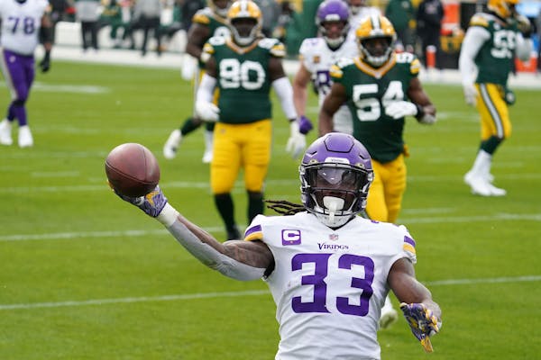 Vikings running back Dalvin Cook held the ball aloft as he scored the first of his four touchdowns on Sunday.