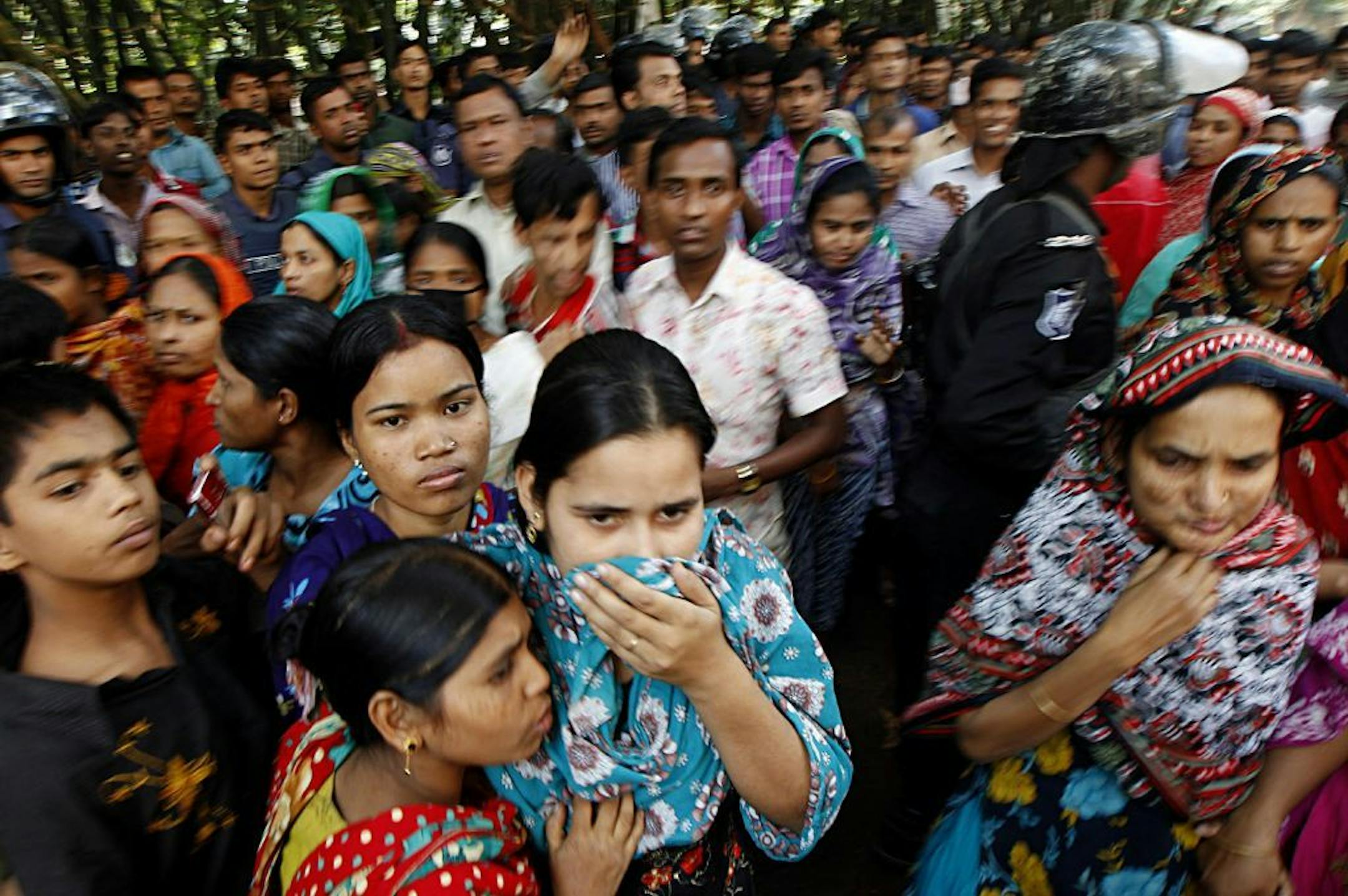 People look at a burnt garment factory outside Dhaka, Bangladesh, Sunday, Nov. 25, 2012. At least 112 people were killed late Saturday night in a fire that raced through the multi-story garment factory just outside of Bangladesh's capital, an official said.