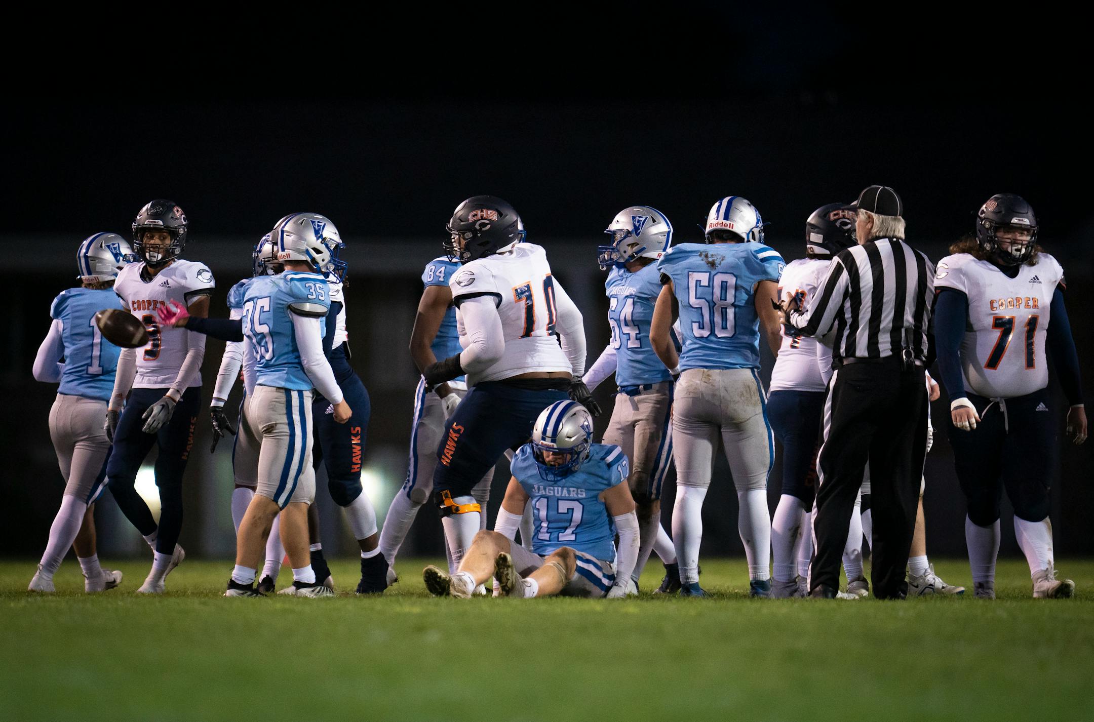 Bloomington Jefferson's Danny King (17) is slow to get up after a play against Robbinsdale Cooper.