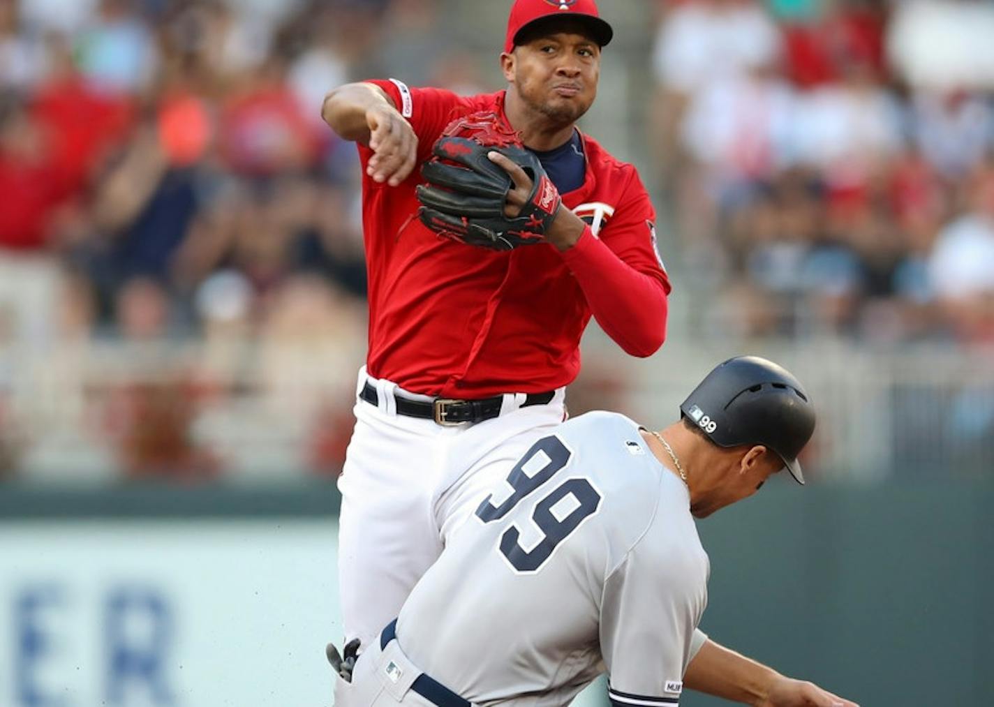 Jonathan Schoop makes the throw at second base to finish off the triple play in Monday's game. Aaron Judge is the sliding Yankees player.