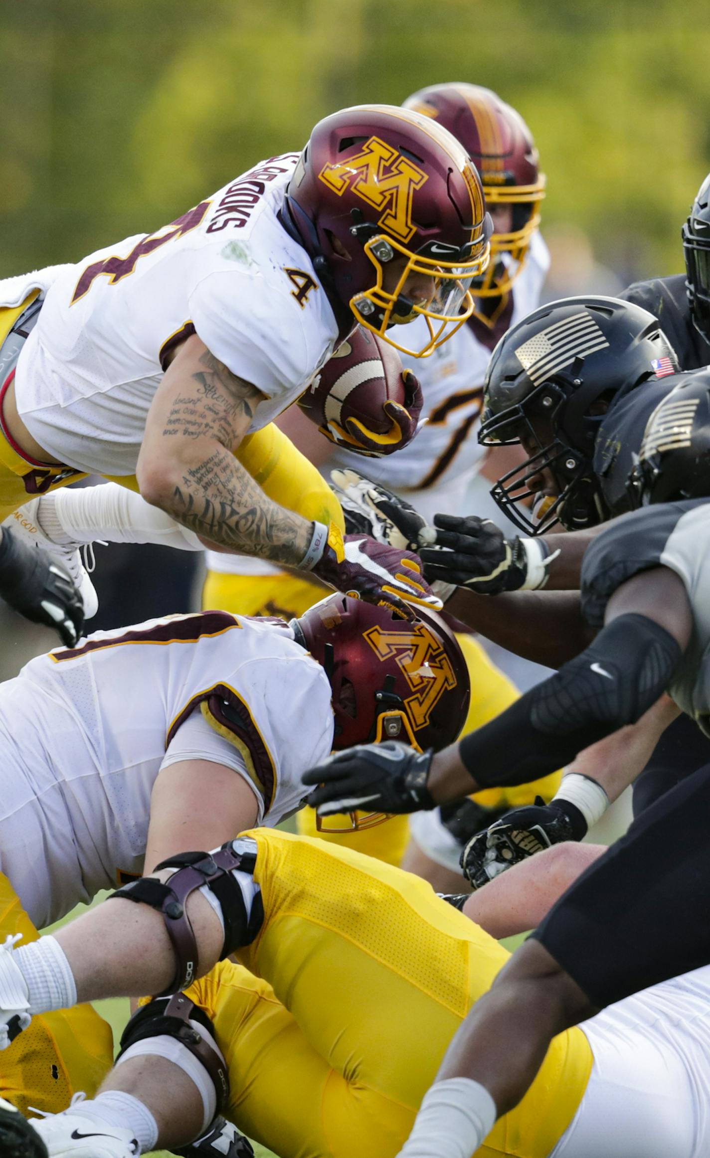 Minnesota running back Shannon Brooks (4) dives to pick up yardage against Purdue during the second half of an NCAA college football game in West Lafayette, Ind., Saturday, Sept. 28, 2019. Minnesota defeated Purdue 38-31. (AP Photo/Michael Conroy)