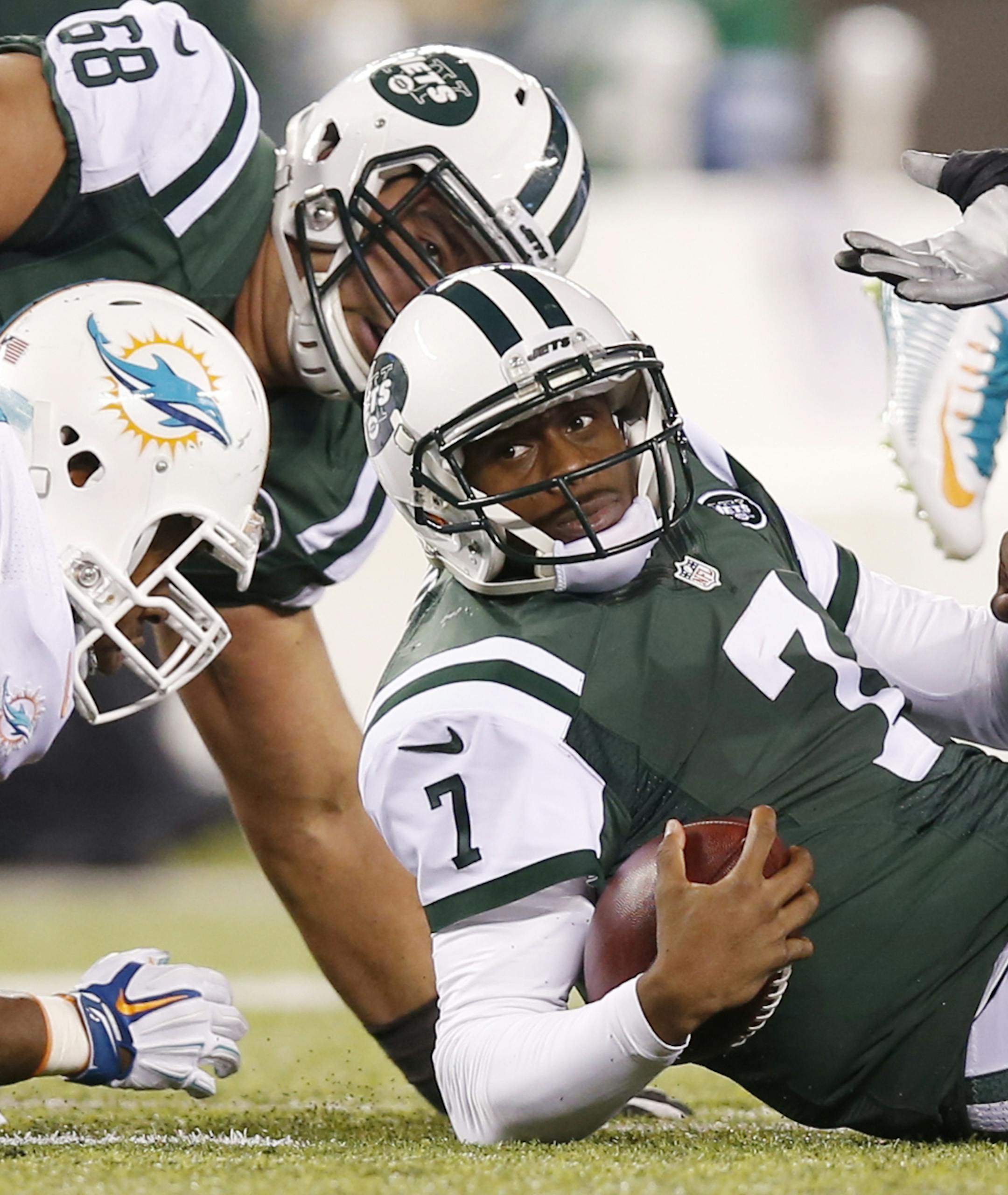 New York Jets quarterback Geno Smith (7) reacts after being sacked by the Miami Dolphins during the fourth quarter of an NFL football game, Monday, Dec. 1, 2014, in East Rutherford, N.J. (AP Photo/Kathy Willens)