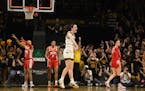 Iowa guard Caitlin Clark (22) celebrates after becoming the all-time leading scorer in NCAA Division I basketball during the first half of an NCAA col