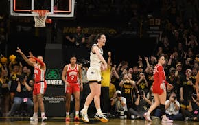 Iowa guard Caitlin Clark (22) celebrates after becoming the all-time leading scorer in NCAA Division I basketball during the first half of an NCAA col