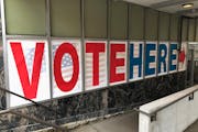A “Vote Here” sign marks the entrance to an early voting station in downtown Minneapolis in 2018. 