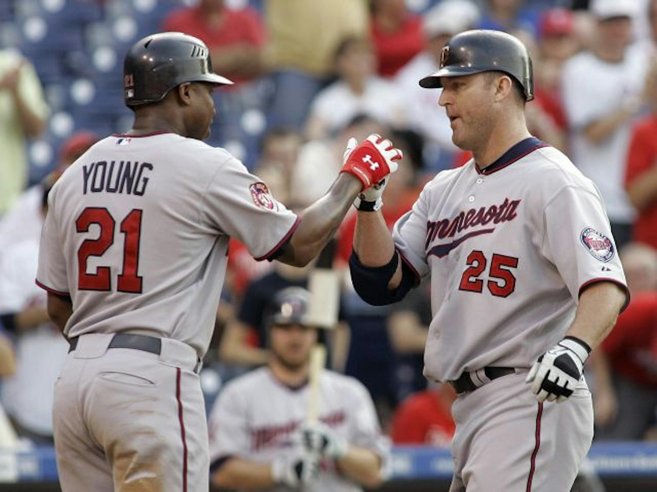 The Twins' Delmon Young greeted Jim Thome at home plate after Thome's two-run homer during the ninth inning against the Phillies on Saturday.