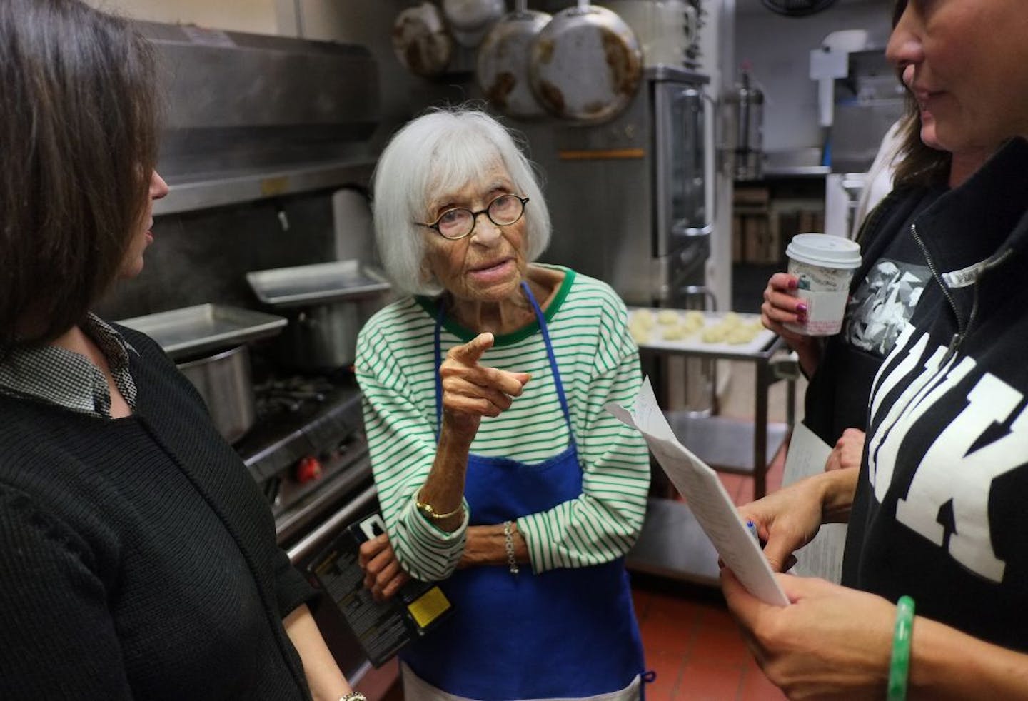 Ruth Knelman prepared to taste her chicken soup in the kitchen of Temple Israel, keeping Ruth Cely nearby because, of course, it needed a little more salt. Student Judy Leviton looked on, seeking secrets of traditional Jewish food from Knelman,who, at 102,knows what she's doing.