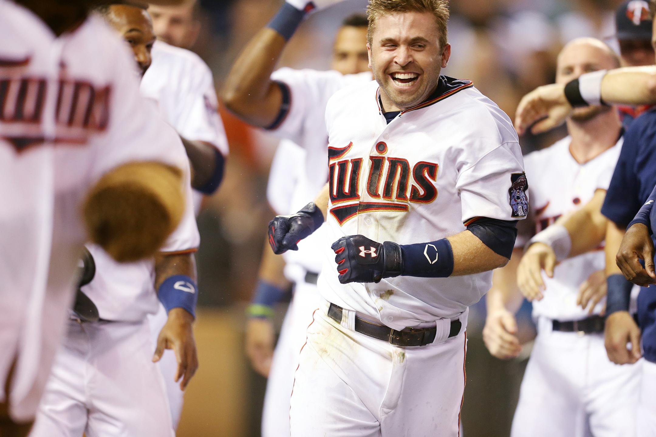 Twins second baseman Brian Dozier was mobbed by teammates after hitting a two-run homer in the 10th inning, giving Minnesota a 4-2 victory over Baltimore on Monday night at Target Field.
