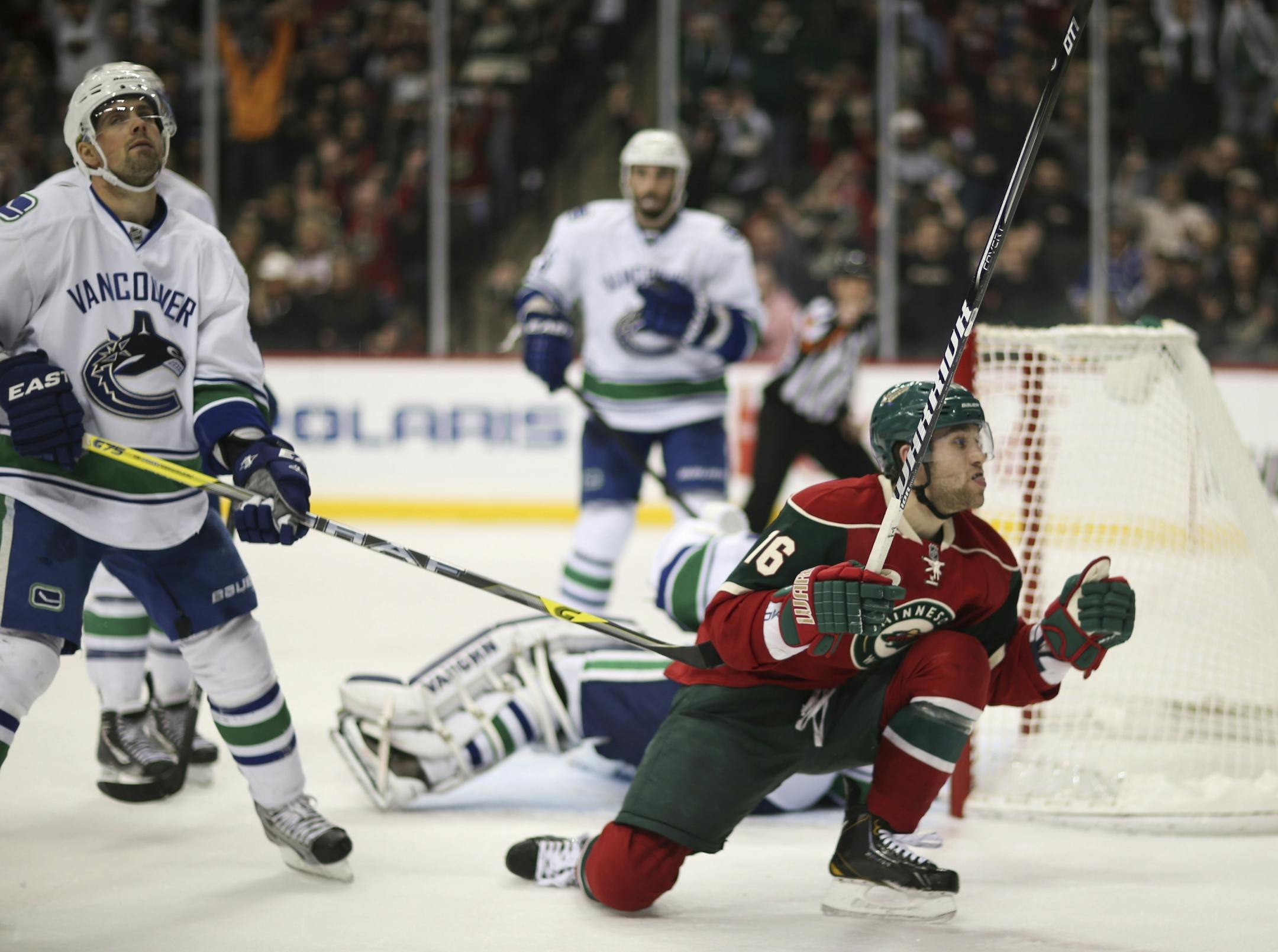 The Minnesota Wild faced the Vancouver Canucks in an NHL hockey game Sunday night, March 10, 2013 at Xcel Energy Center in St. Paul, Minn. The Wild's Jason Zucker celebrated his first period goal after he poked the puck past Vancouver goalie Cory Schneider to give the Wild a 2-0 lead Sunday night. Vancouver's Dan Hamhuis was at left.