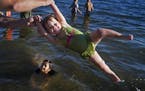 At Lake Harriet in Minneapolis, Lillian Hebert, 2, was twirled around by her dad, Nick, while her friend Evelyn Lee, 7, splashed around on Sunday.