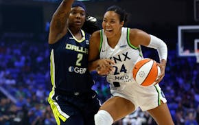 The Lynx's Napheesa Collier handles the ball against Dallas' Myisha Hines-Allen during the first half Friday.