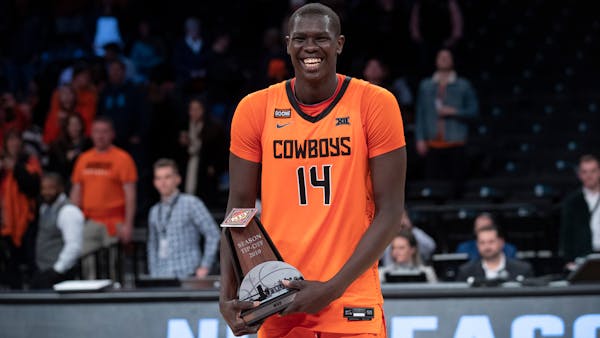 Oklahoma State forward Yor Anei poses for for a photo with his MVP trophy after Oklahoma State defeated Mississippi in the NCAA college basketball NIT