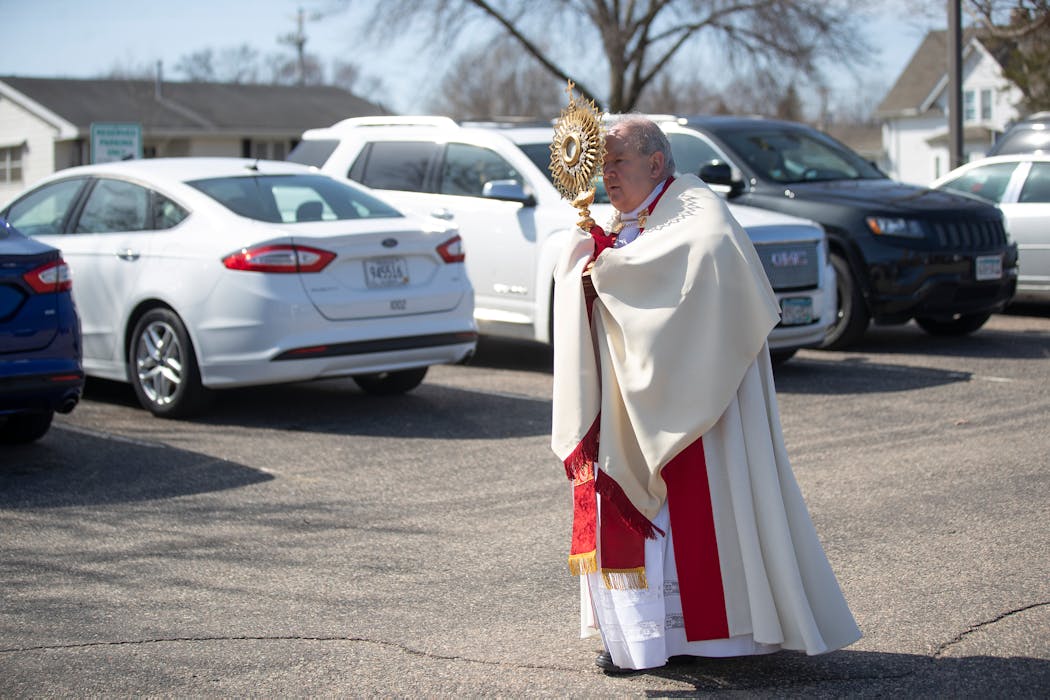 Archbishop Bernard Hebda led a procession through cars in the church parking lot of Parish of Saints Joachim and Anne in Shakopee on Palm Sunday, April 5