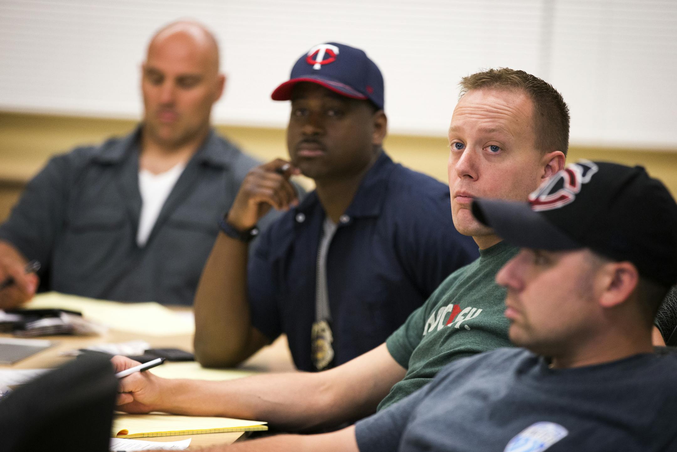 Members of the Minneapolis Police Department’s newly formed Gang Interdiction Team, from left, officers Donnell Crayton, Corey Schmidt and Nick Englund, attended a briefing and training session Wednesday in Fridley.