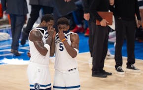 Minnesota Timberwolves forward Julius Randle (30) and guard Anthony Edwards (5) conferred after a timeout in the third quarter of Wednesday's season-e