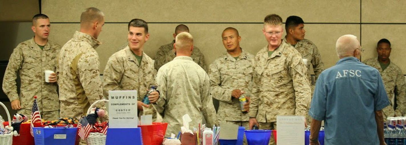 In this 2009 photo, a group of Marines en route to the home base in Arizona are greeted -- and fed -- by volunteers from the Armed Forces Service Center at the Minneapolis-St. Paul airport. The center is open 24 hours a day to welcome traveling service members and military dependents and retirees.