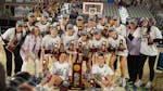 The Minnesota State Mankato women's basketball team posed with its championship trophy after beating Texas Woman's on Friday night in St. Joseph, Mo.,