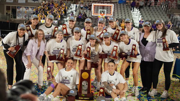 The Minnesota State Mankato women's basketball team posed with its championship trophy after beating Texas Woman's on Friday night in St. Joseph, Mo.,