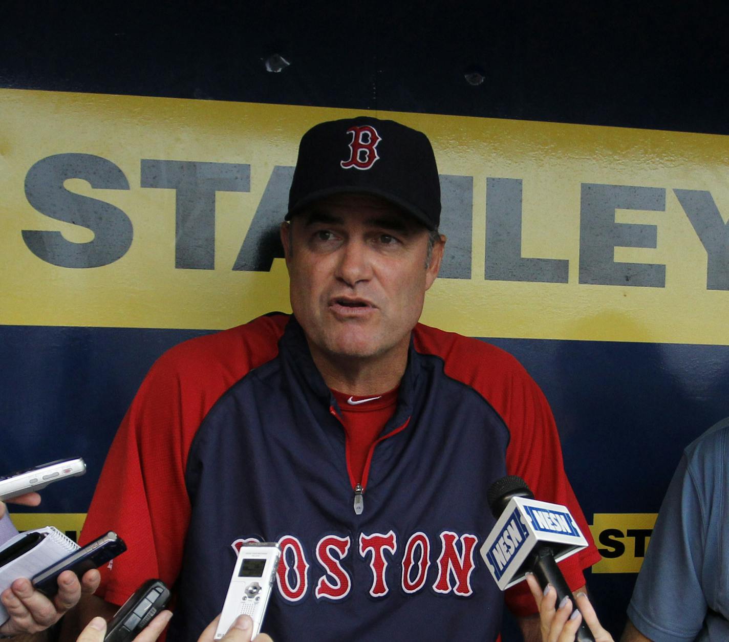 Boston Red Sox manager John Farrell, center, talks to members of the media during batting practice before of a baseball game against the Kansas City Royals at Kauffman Stadium in Kansas City, Mo., Thursday, Aug. 8, 2013. (AP Photo/Colin E. Braley)