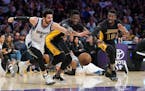Minnesota Timberwolves guard Ricky Rubio, left, of Spain, scrambles for a loose ball along with Los Angeles Lakers forward Julius Randle, center, and 
