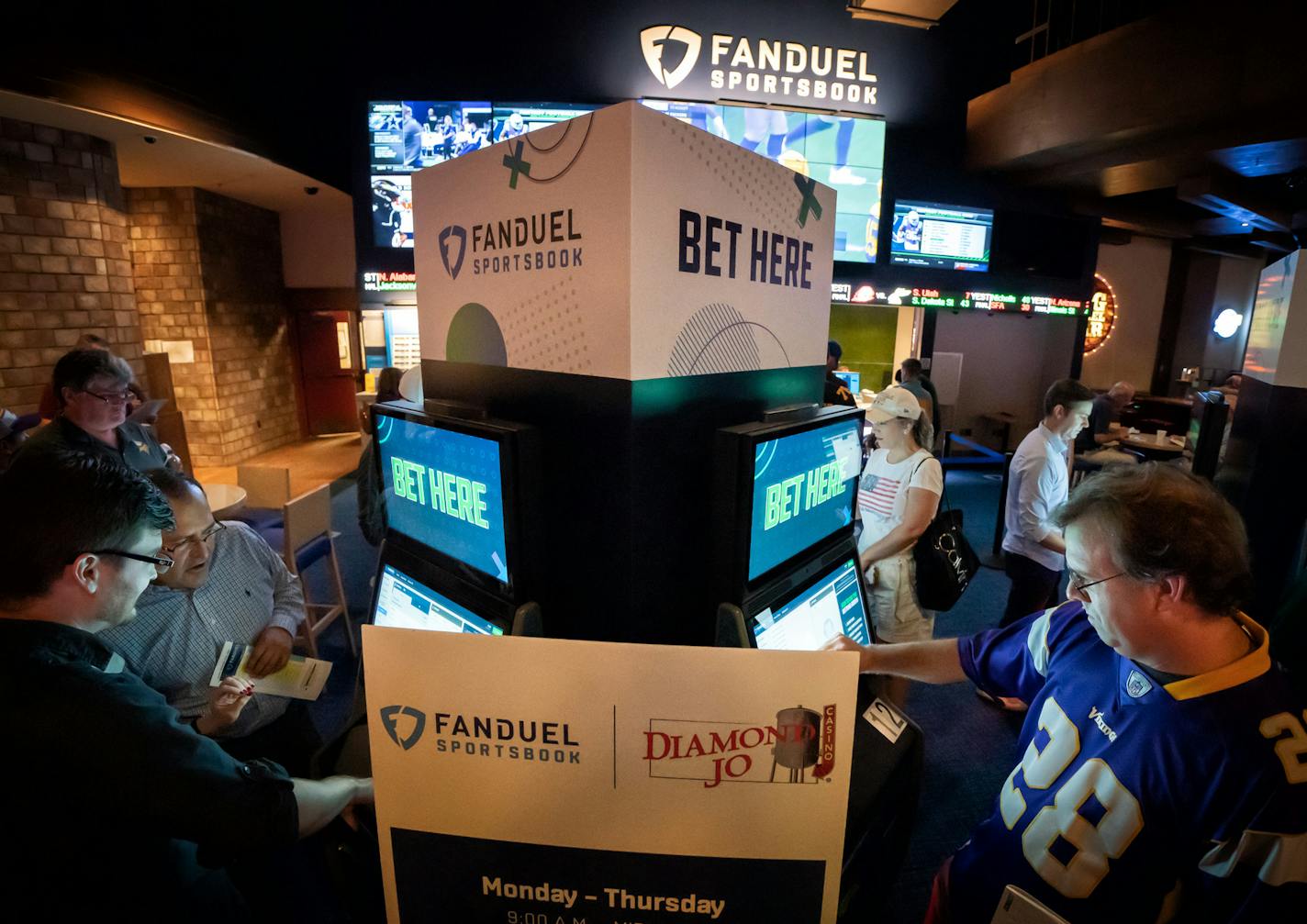 State Reps. Jon Koznick, left, and Pat Garofalo placed bets at FanDuel Sportsbook in Diamond Jo Casino. Garofalo led a trip to the casino just across the border in Northwood, Iowa, to see how legalized sports betting worked as the Minnesota Vikings played the Oakland Raiders on Sunday, Sept. 22.