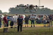 Farmfest attendees gathered to watch ABC Drones of Rochester demonstrate how drones can be used to selectively spray crops.