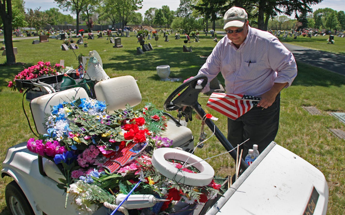 Stolen flowers is one problem at cemeteries. Another is excessive clutter. On Wednesday, manager Dan Kantar of Mound Cemetery in Brooklyn Center made the rounds, picking up leftover garbage.