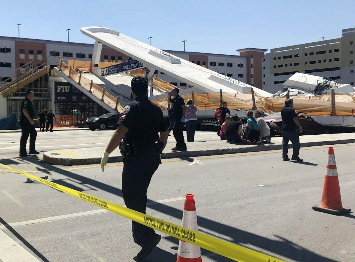 Emergency personnel work at the scene of a collapsed pedestrian bridge at Florida International University on Thursday, March 15, 2018, in the Miami area.