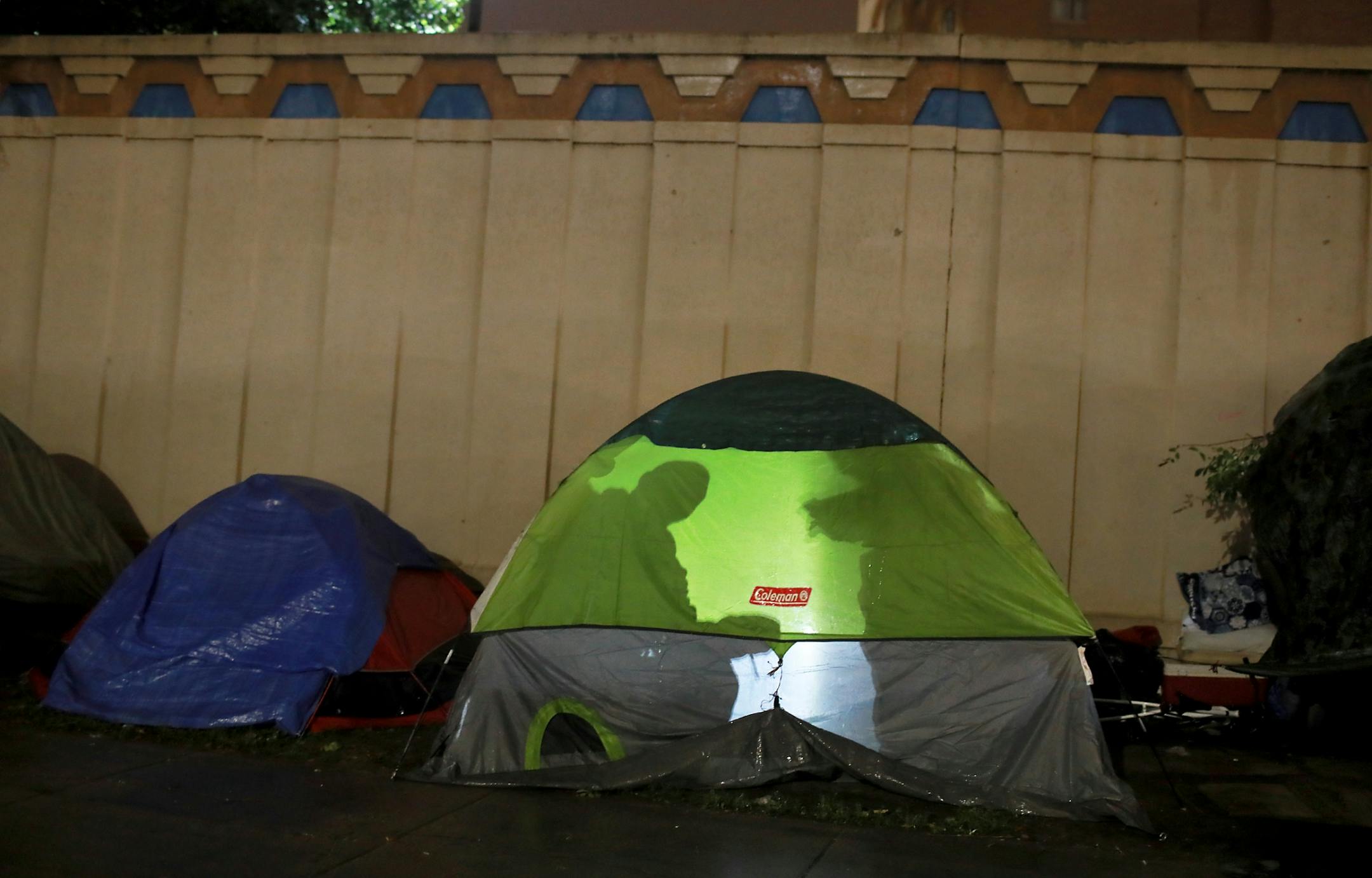 Shadows of homeless residents of a large homeless encampment are visible from a tent Thursday, Oct. 4, 2018, in Minneapolis, MN.