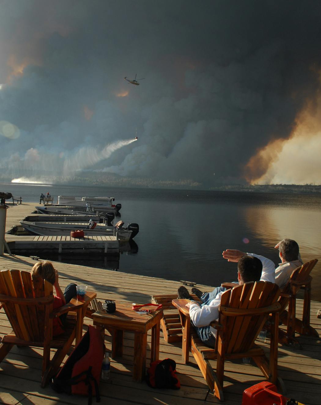 People watched a prescribed burn from the docks at Gunflint Lodge in 2007. The rapid Ham Lake fire caught many in the wilderness area off guard.