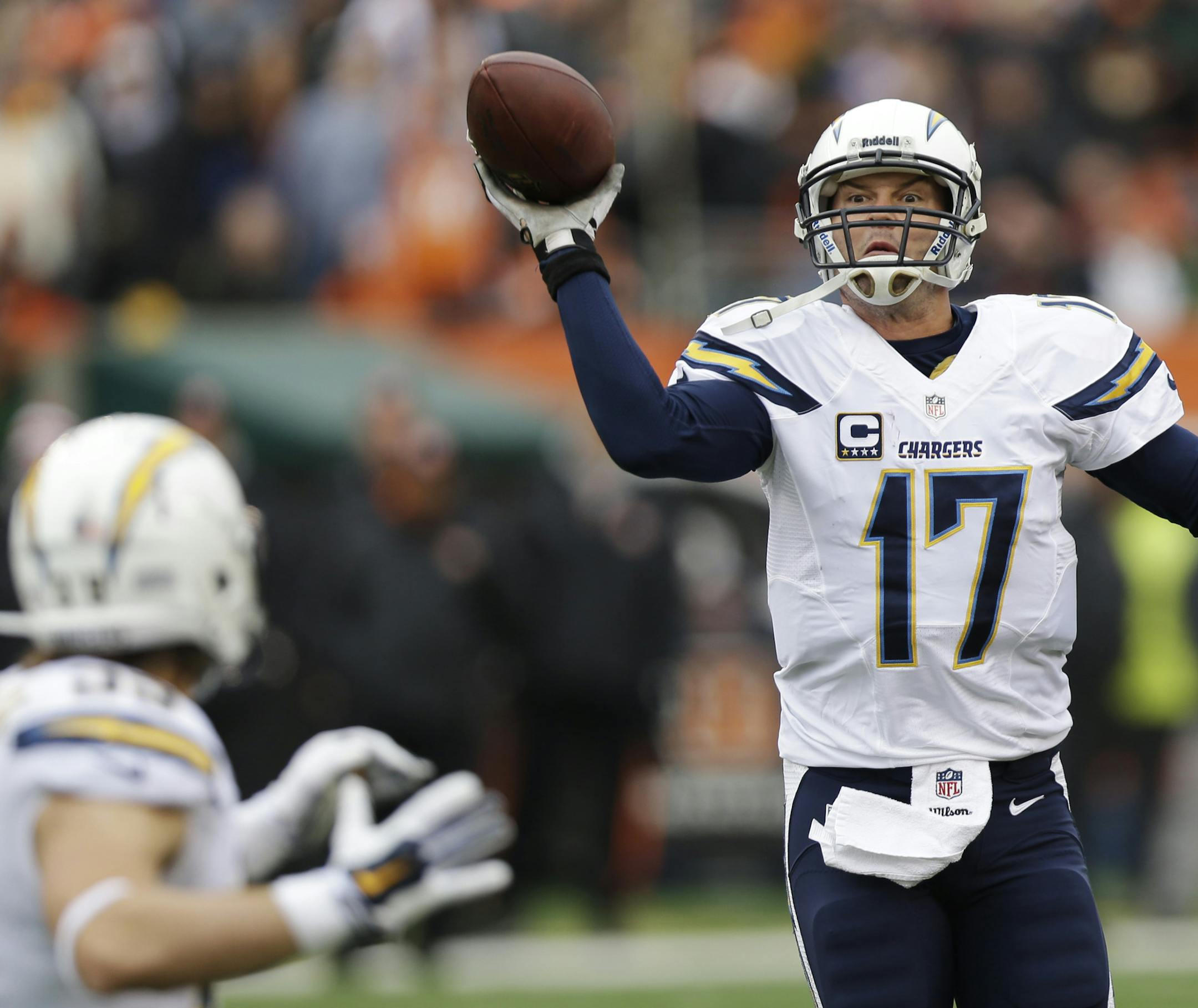 San Diego Chargers quarterback Philip Rivers (17) tosses a pass to running back Danny Woodhead in the second half of an NFL wild-card playoff football game against the Cincinnati Bengals, Sunday, Jan. 5, 2014, in Cincinnati. (AP Photo/Al Behrman)