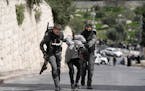 Israeli Border Police detain a Palestinian man ahead of Friday prayers at the Al-Aqsa Mosque compound in the Old City of Jerusalem, Friday, March 1, 2