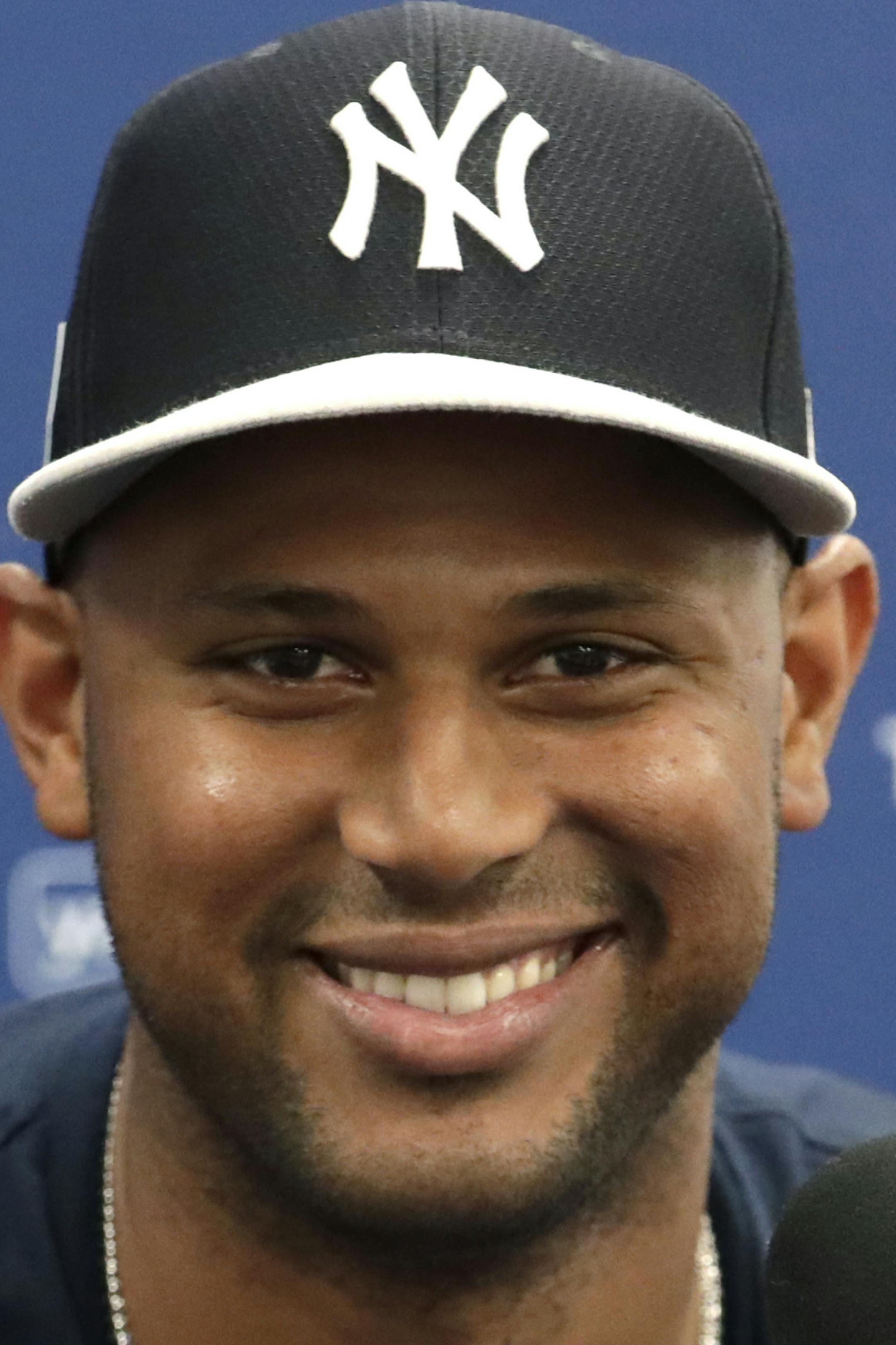 New York Yankees' Aaron Hicks smiles during a news conference before a spring training baseball game against the Toronto Blue Jays, Monday, Feb. 25, 2019, in Tampa, Fla. The Yankees announced that Hicks signed a seven-year contract Monday. (AP Photo/Lynne Sladky)