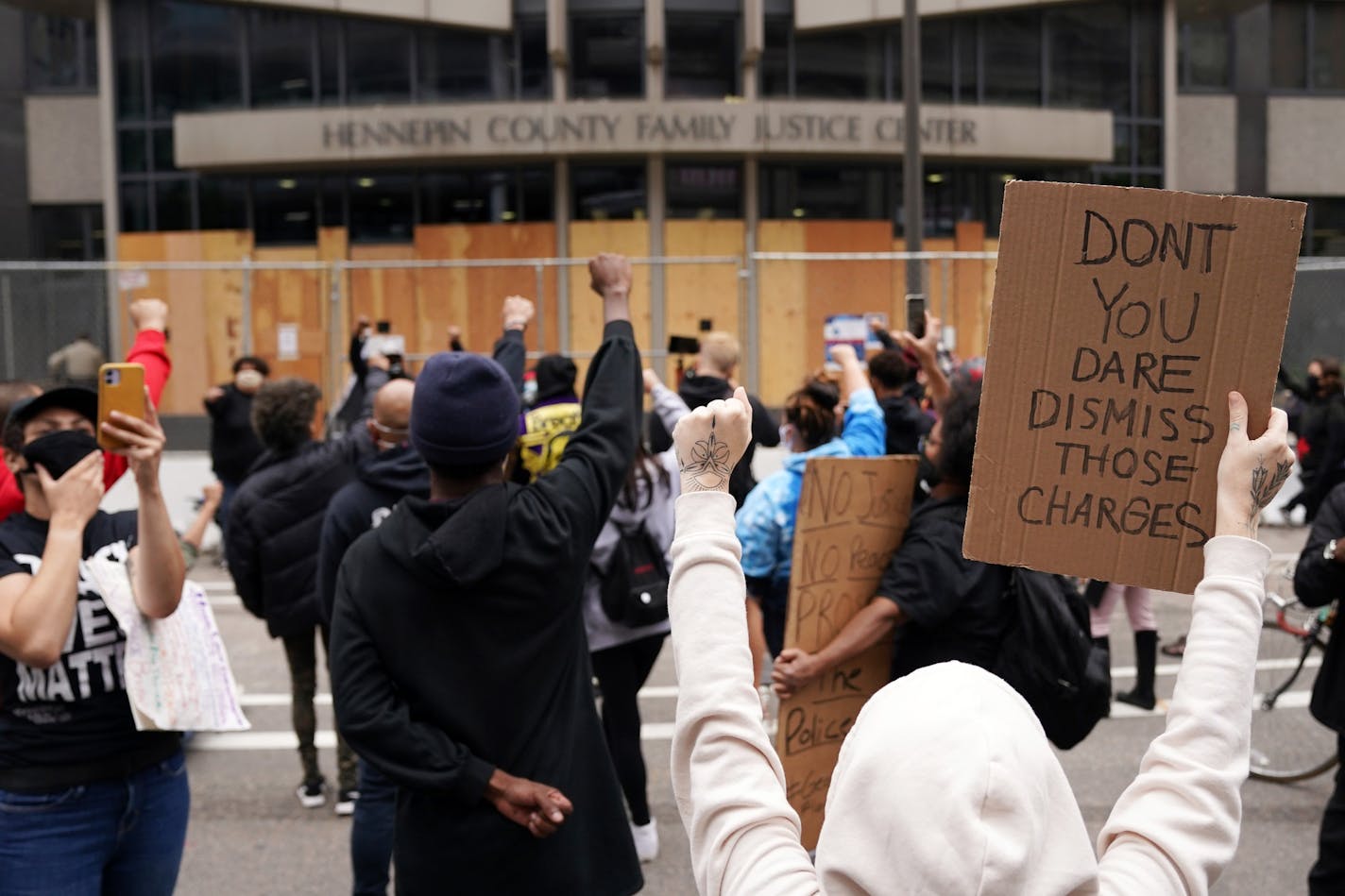 Protesters chanted outside the Hennepin County Family Justice Center following a hearing on several pending motions in the cases against four former officers in the killing of George Floyd. ] ANTHONY SOUFFLE • anthony.souffle@startribune.com A judge heard oral arguments on several pending motions in the cases against four former officers in the killing of George Floyd, including motions to dismiss the cases, Friday, Sept. 11, 2020 at the Hennepin County Family Justice Center in downtown Minneapo