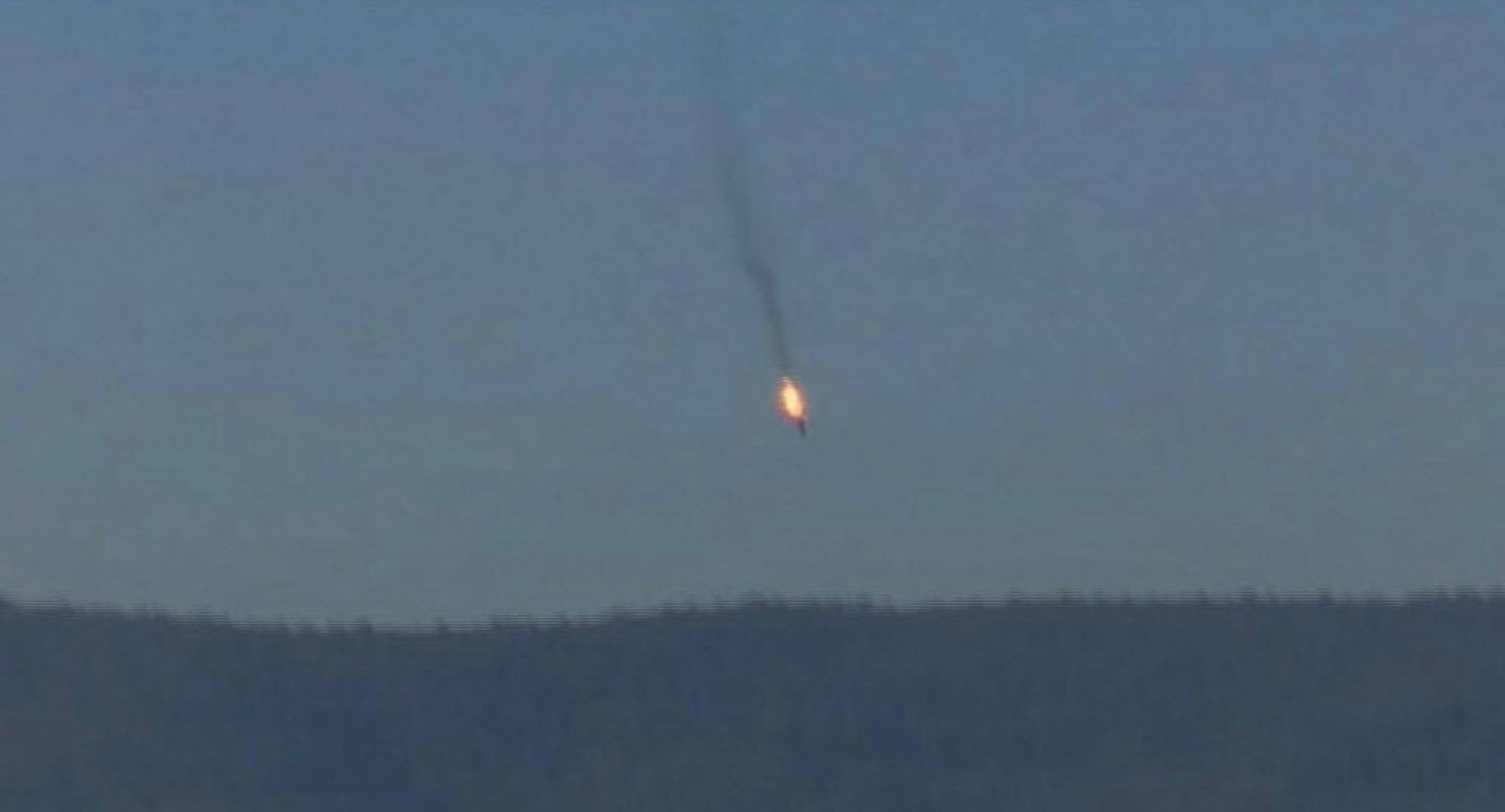 This frame grab from video by Haberturk TV, shows a Russian warplane on fire before crashing on a hill as seen from Hatay province, Turkey, Tuesday, Nov. 24, 2015. Turkey shot down the Russian warplane Tuesday, claiming it had violated Turkish airspace and ignored repeated warnings. Russia denied that the plane crossed the Syrian border into Turkish skies.