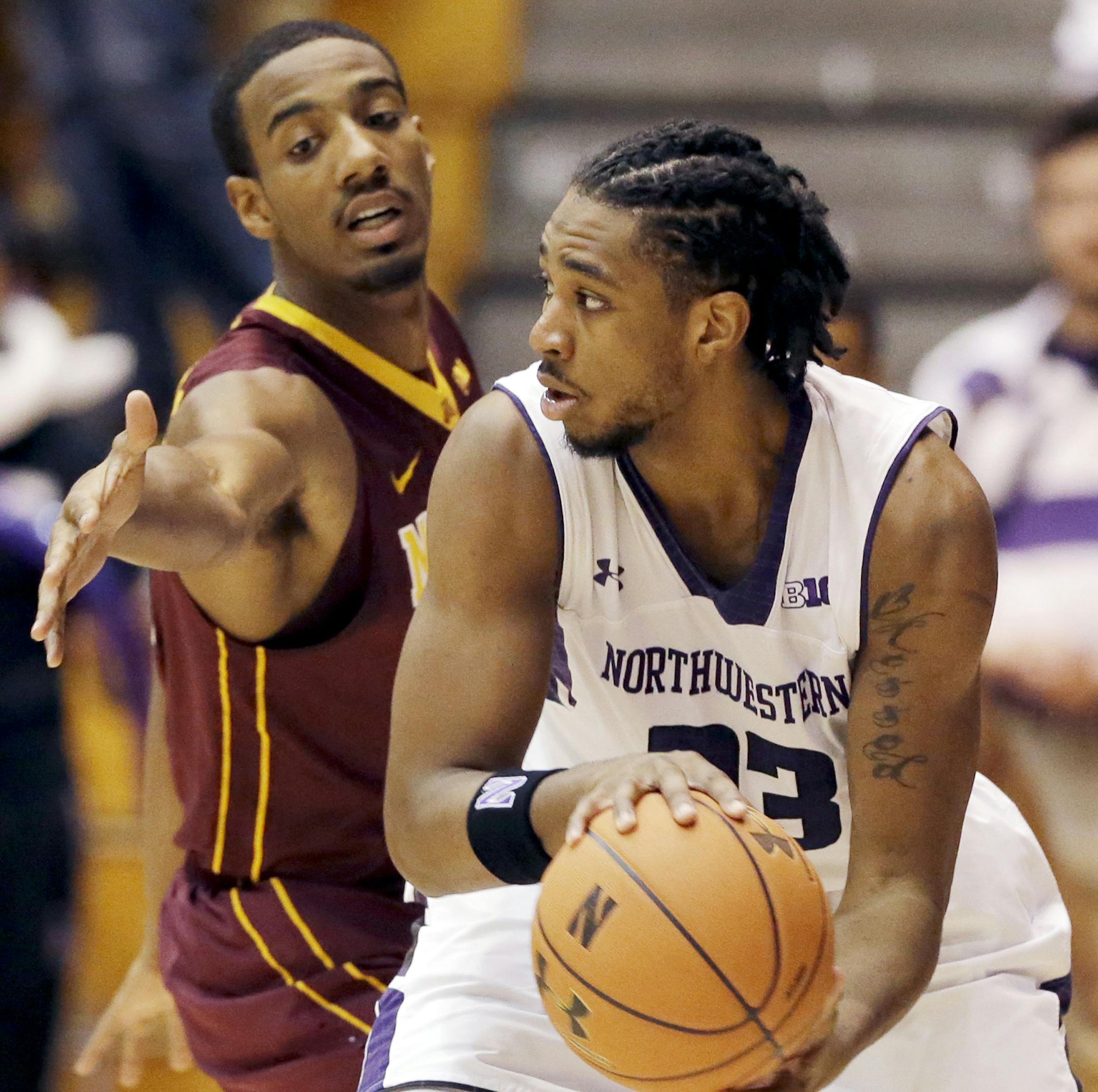 Northwestern guard JerShon Cobb, right, looks to pass as Minnesota guard Austin Hollins guards during the first half of an NCAA college basketball game in Evanston, Ill., Sunday, Feb. 16, 2014. (AP Photo/Nam Y. Huh)
