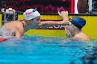 Lakeville's Regan Smith congratulates Gretchen Walsh after her world record in her Women's 100 butterfly semifinals heat Saturday at the US Swimming O