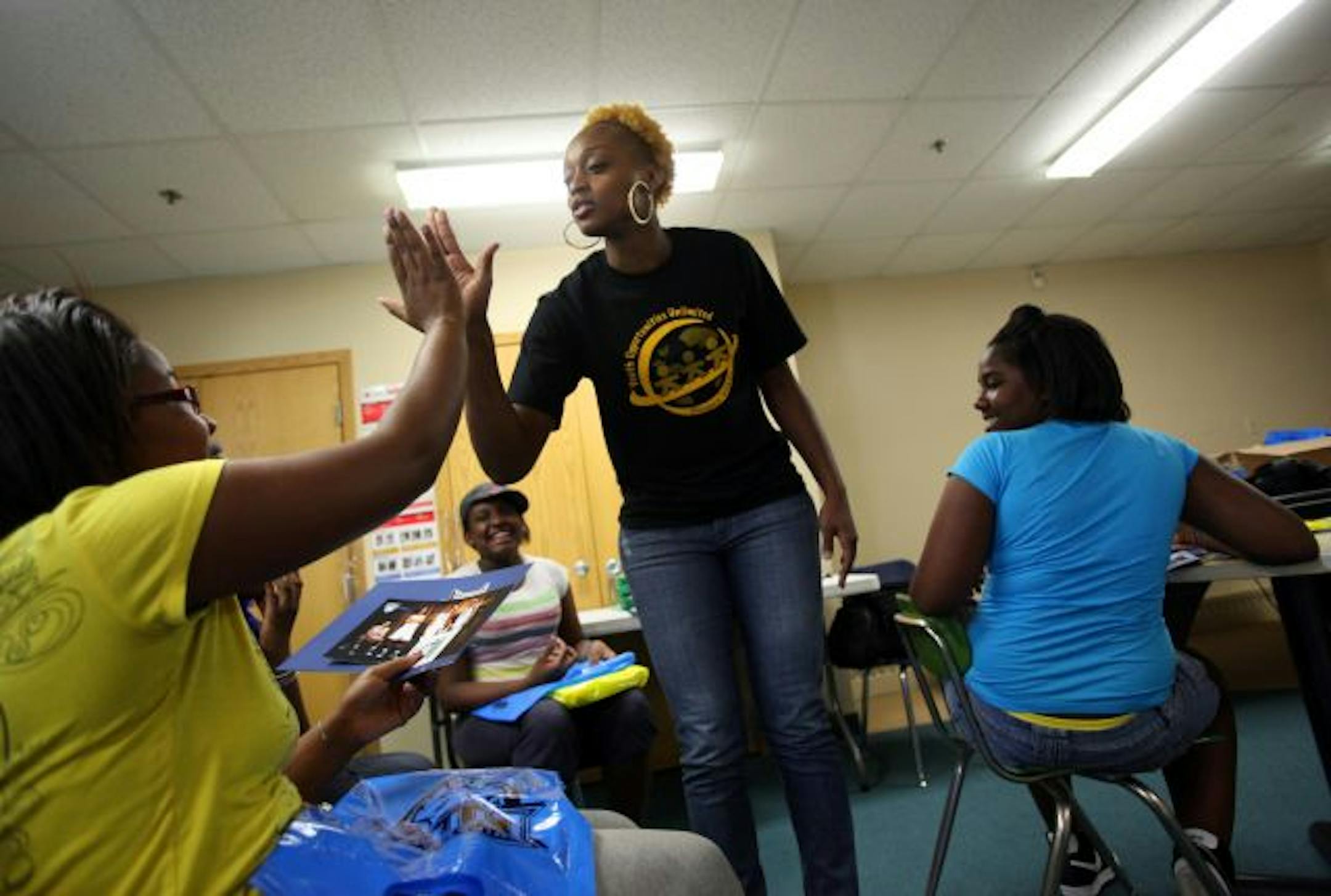 Charde Houston, center, gave a high-five to DaRonda Stevson, 14, as she got to know the girls in the six-week leadership program she started recently with Perspectives Inc. in St. Louis Park.