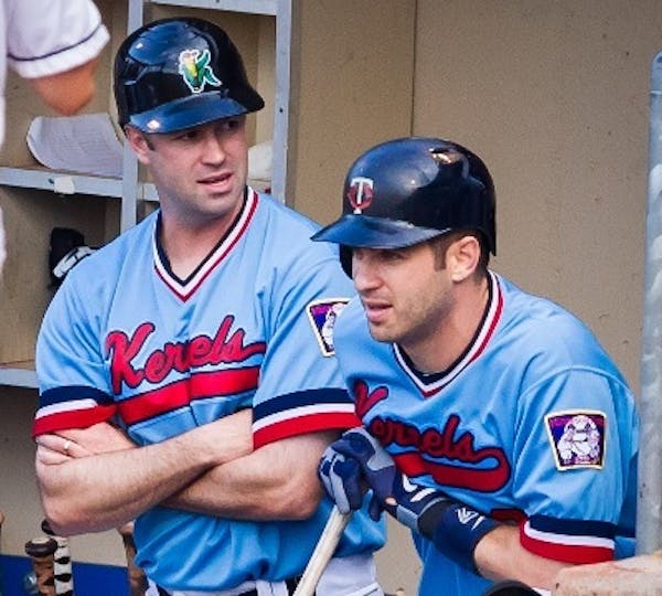 Brothers Jake, left, and Joe Mauer chatted before Joe's first at-bat for the Cedar Rapids Kernels against the Wisconsin Timber Rattlers in August of 2