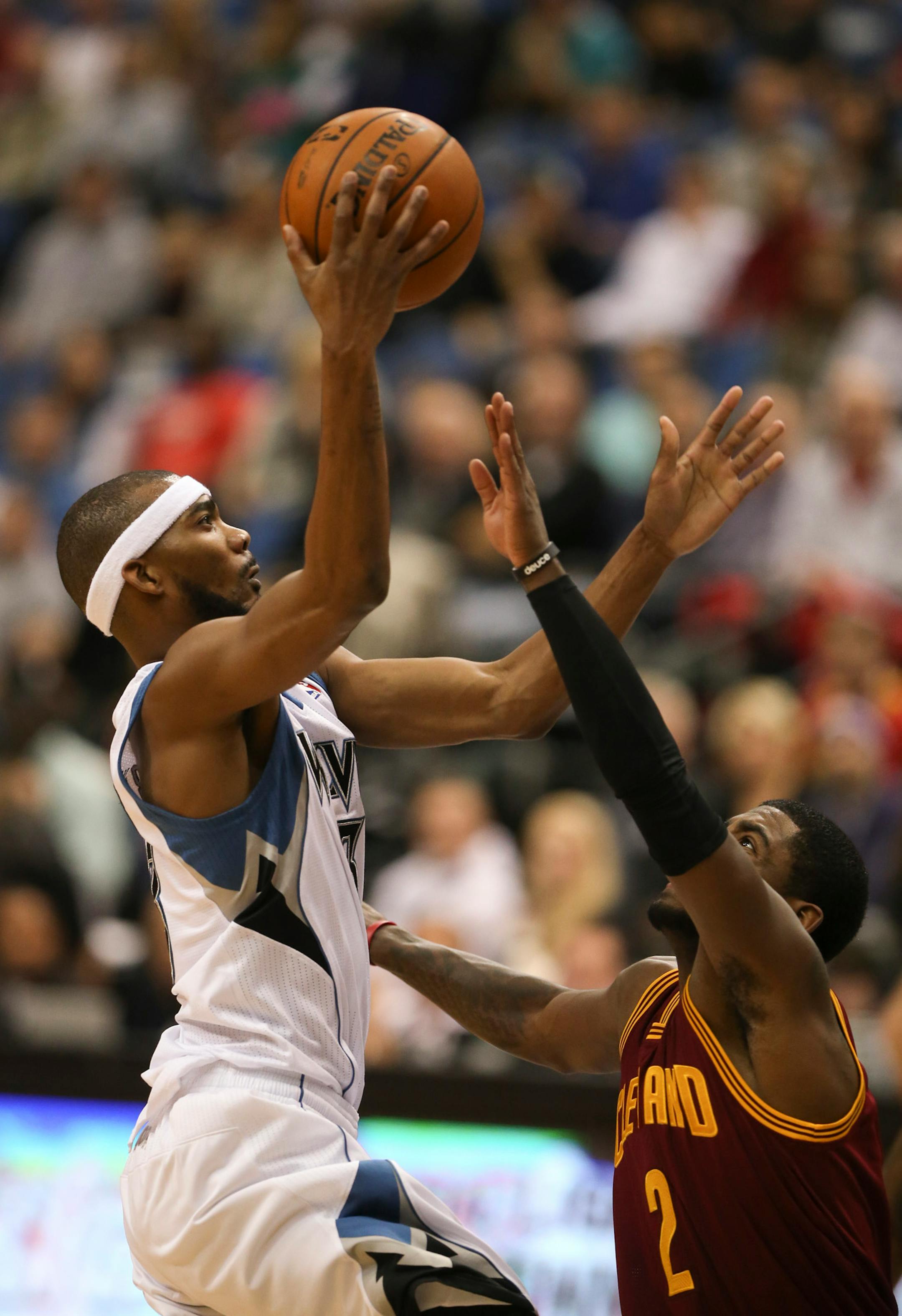 Minnesota Timberwolves small forward Corey Brewer (13) took a first quarter shot over the defense of Cleveland Cavaliers point guard Kyrie Irving (2). He was the second highest scorer with 27 points.
