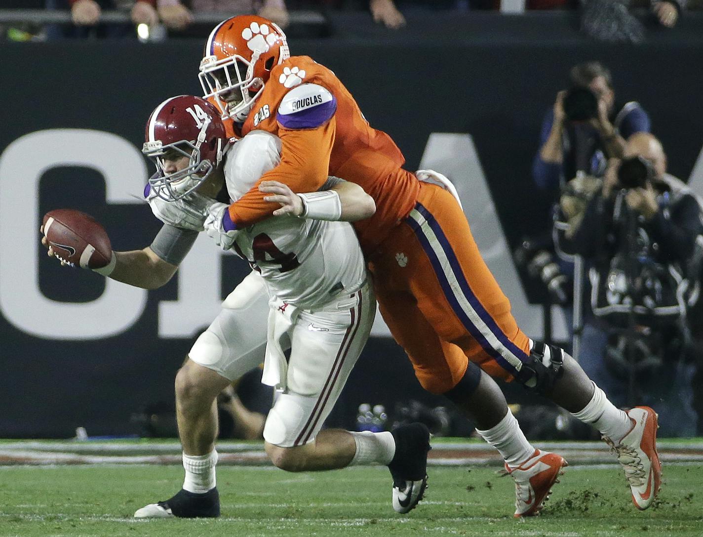 Clemson's Shaq Lawson, right, sacks Alabama's Jake Coker during the first half of the NCAA college football playoff championship game Monday, Jan. 11, 2016, in Glendale, Ariz. (AP Photo/David J. Phillip)