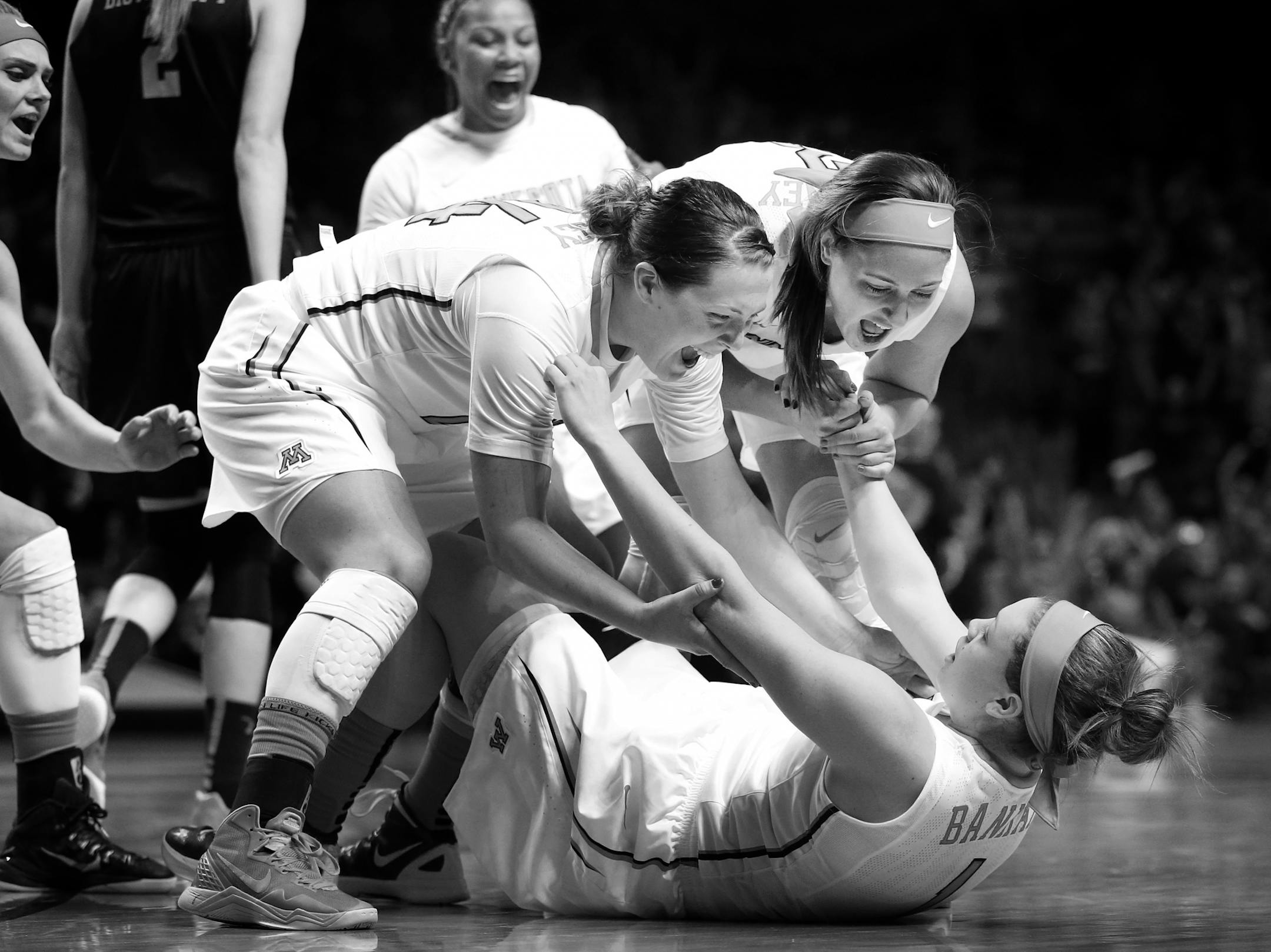 Mikayla Bailey (24) and Shayne Mullaney (3) picked up Rachel Banham (1) at the end of the game. Rachel Banham (1) made a three pointer in the in the final second of the game. Minnesota beat Iowa by a final score of 78-76. Banham finished with 35 points.