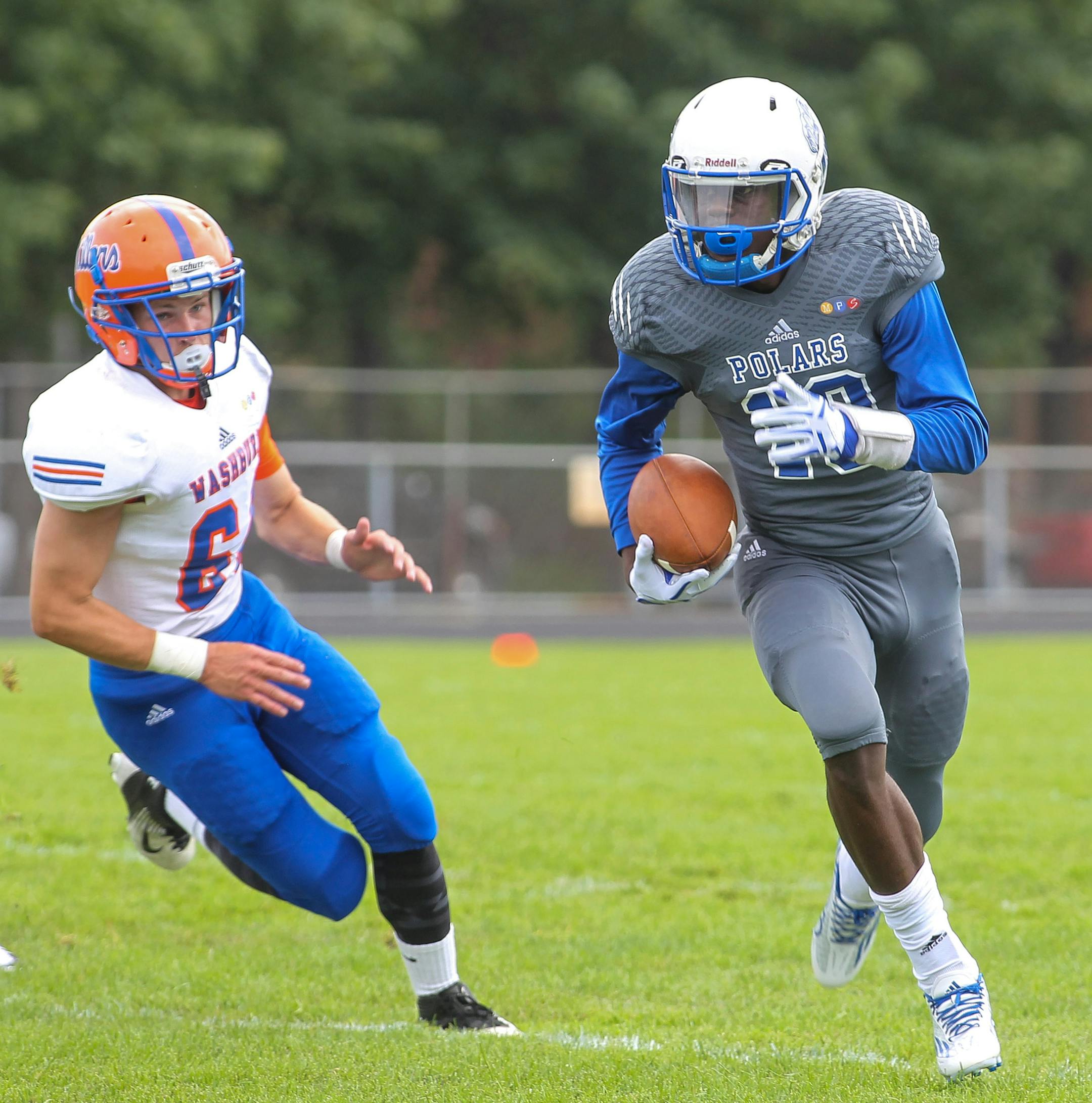 Minneapolis North quarterback Tyler Johnson looks for running room in a 42-8 victory over Minneapolis Washburnl, 8-22-15. Photo by Mark Hvidsten