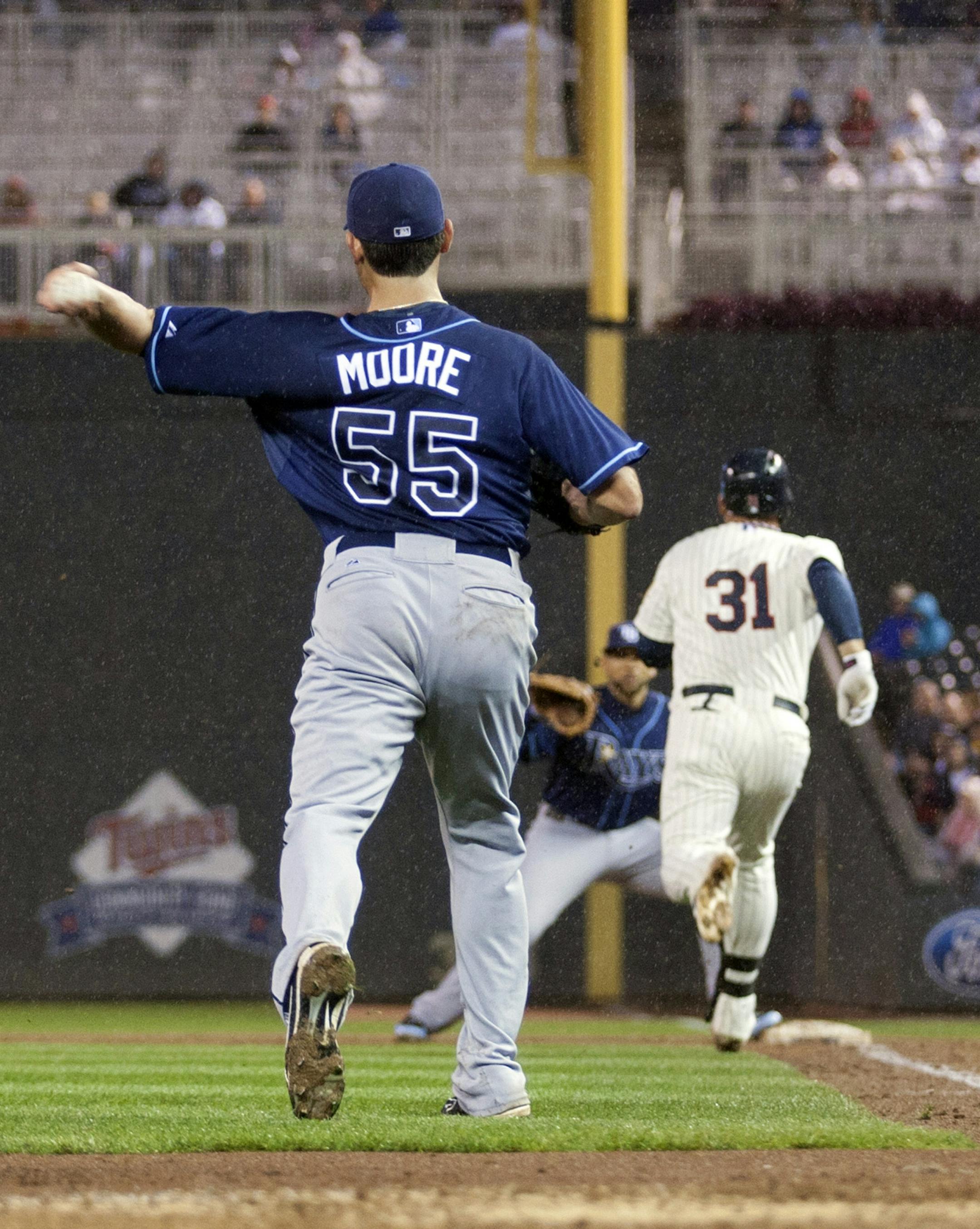 Tampa Bay Rays starting pitcher Matt Moore (55) throws out Minnesota Twins' Oswaldo Arcia (31) at first during the third inning of a baseball game, Saturday, Sept. 14, 2013, in Minneapolis. (AP Photo/Paul Battaglia) ORG XMIT: MIN2013091420453163
