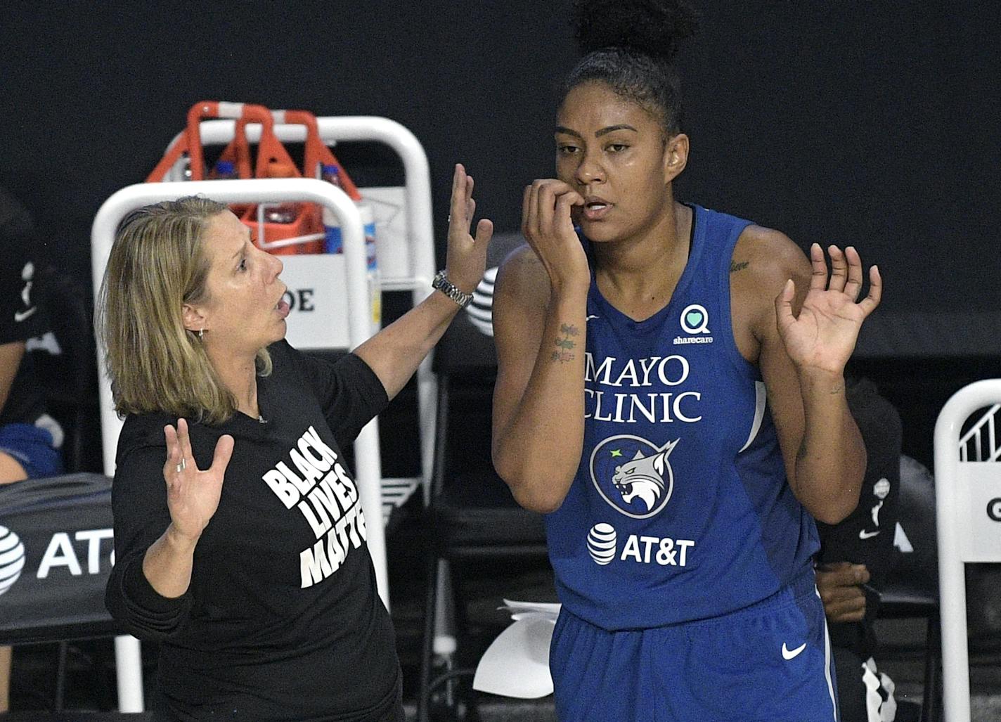 Minnesota Lynx head coach Cheryl Reeve, left, talks with forward Damiris Dantas during the second half of a WNBA basketball game against the Connecticut Sun, Sunday, July 26, 2020, in Bradenton, Fla. (AP Photo/Phelan M. Ebenhack)